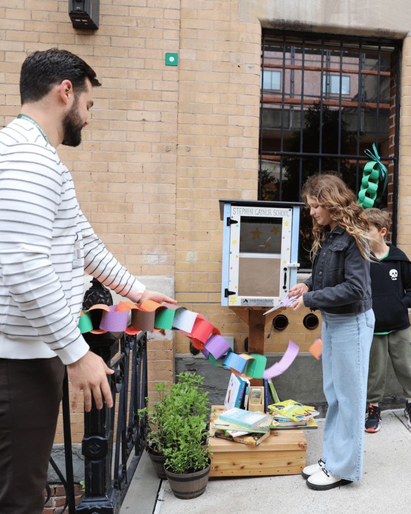 Cutting the ribbon to open the Little Free Library